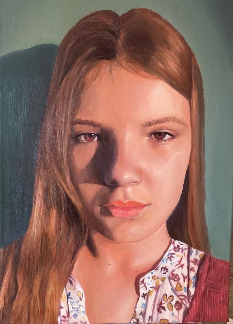 Oil portrait of a girl in warm evening light.