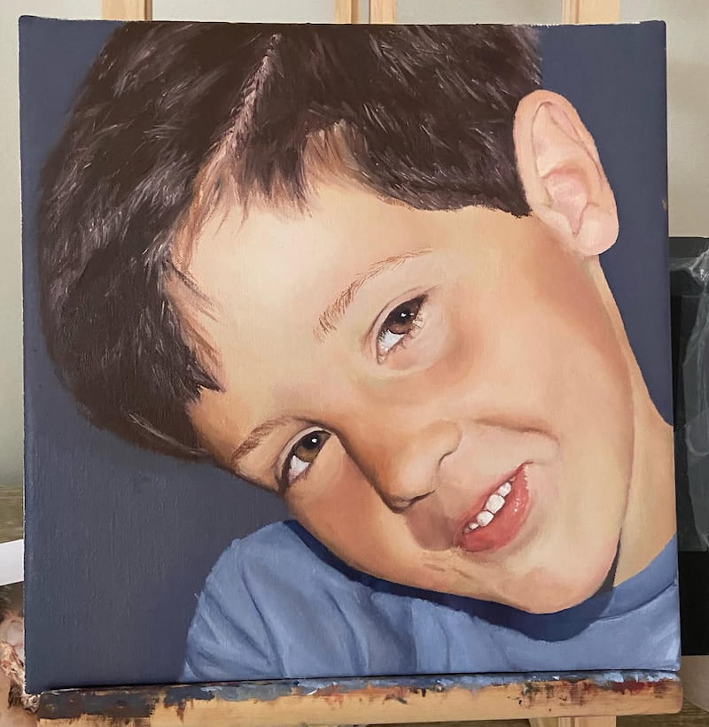 Oil portrait of a smiling boy.
